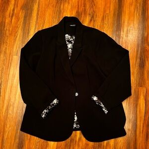 Black blazer with flower print inside.